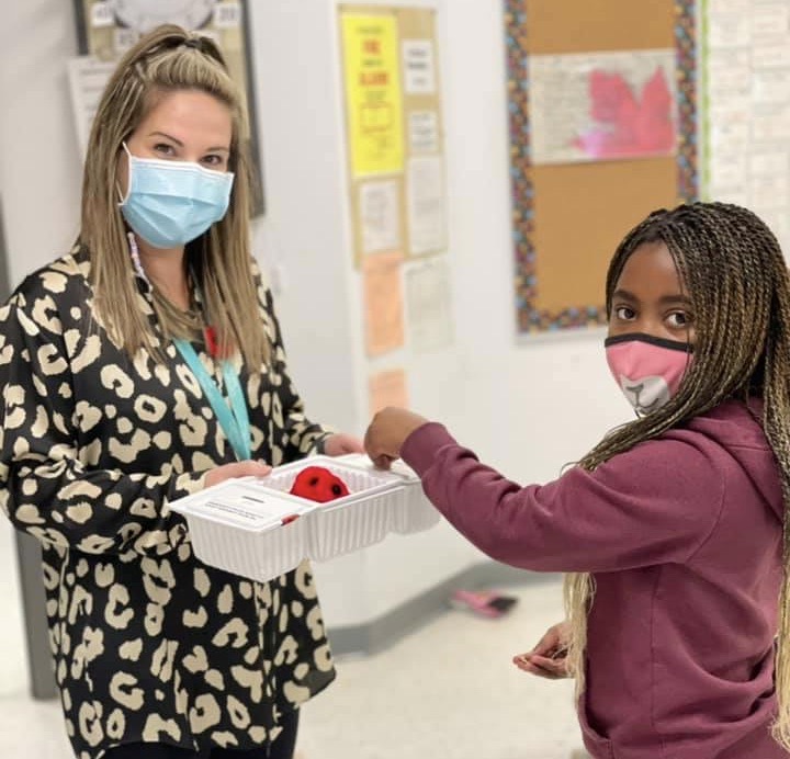 Teacher hands out poppies